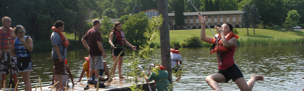 A group of youth using the rope swing