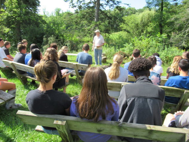 Jim teaching outdoors with a group of high school students