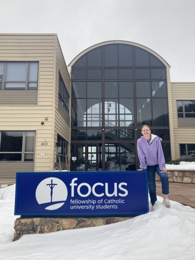 Cara stands in front of the Denver FOCUS headquarters.