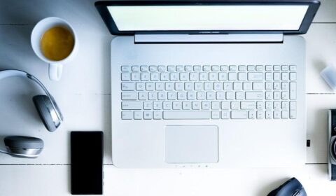 Office laptop and mouse, coffee cup