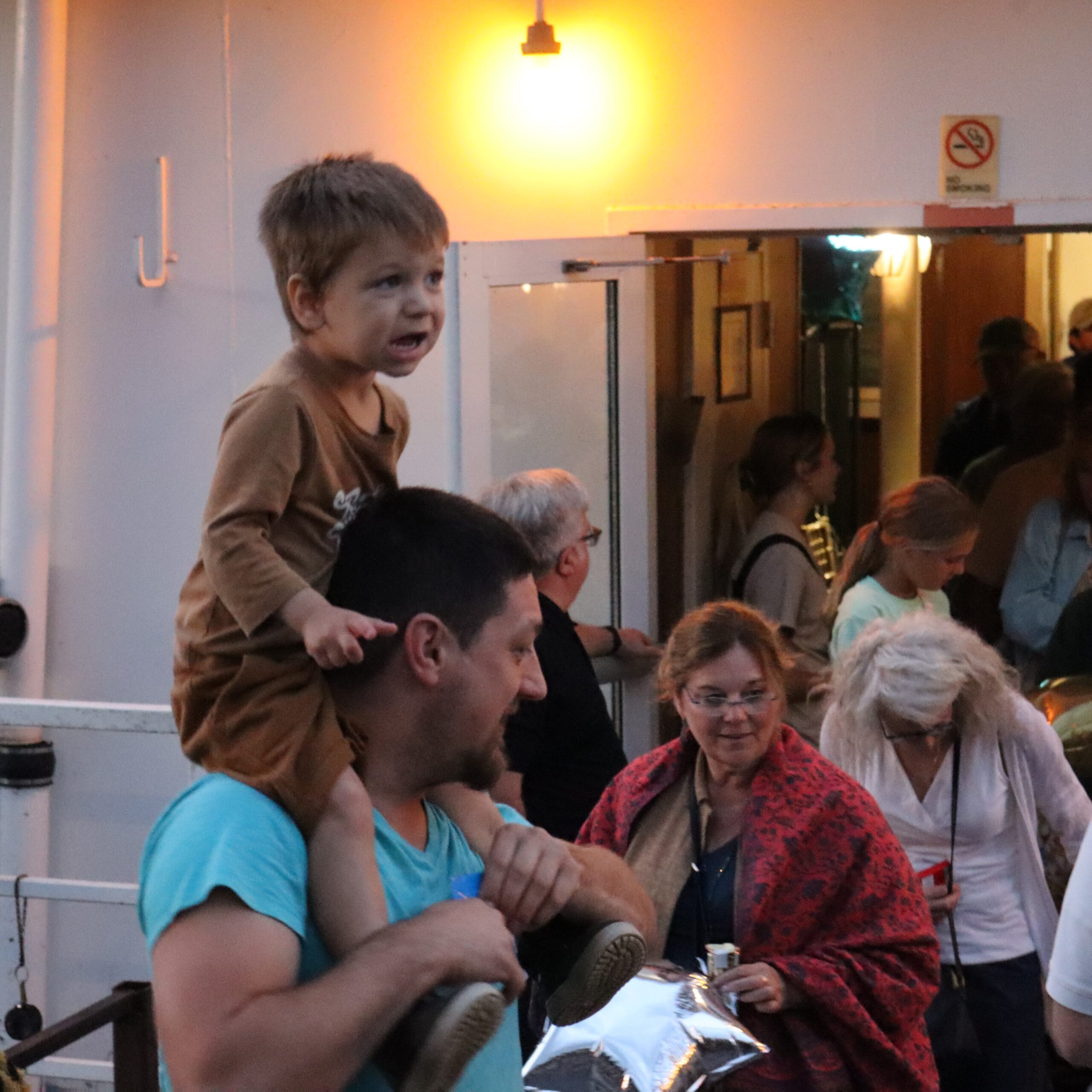 Sitting on dad’s shoulders