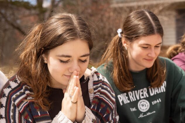 Two high school girls in prayer